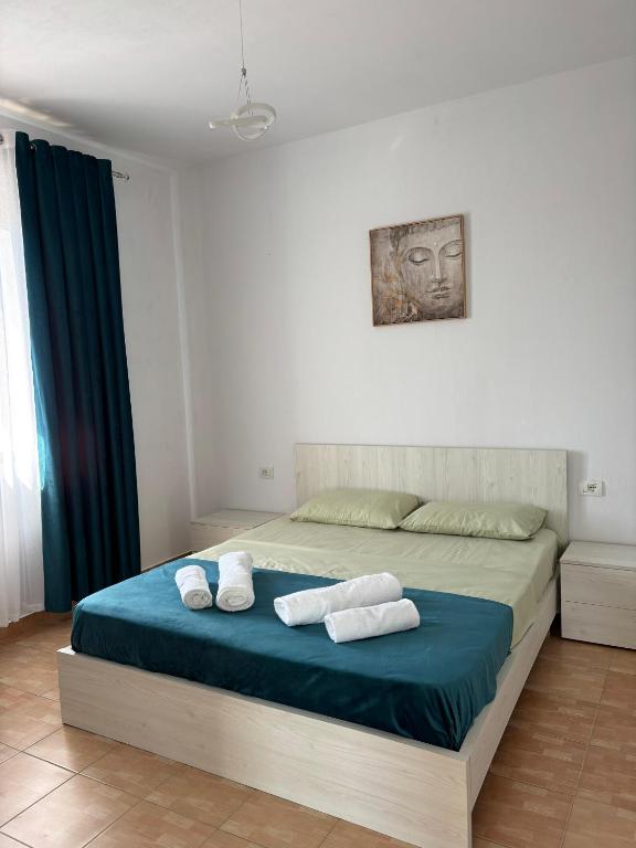 a bedroom with a bed with two towels on it at Villa 7 in Durrës
