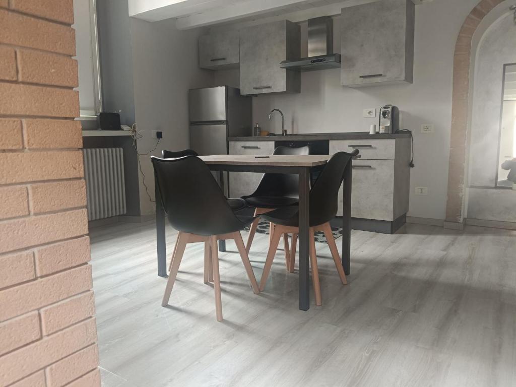 a kitchen with a table and two chairs at Living Milano Suite in Cinisello Balsamo