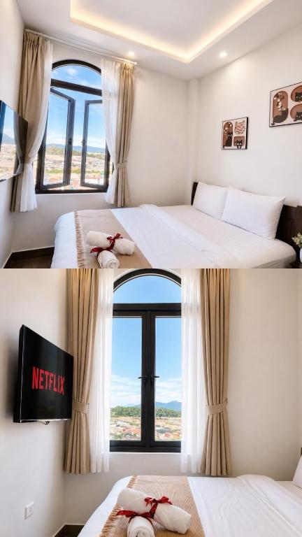 two beds in a room with a window at Amelia House - Boutique Hotel in Khu Chi Lăng