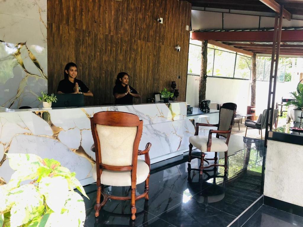 two women sitting at a counter in a salon at Tepraas Sigiriya in Sigiriya