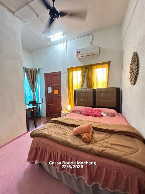 a bedroom with a large bed with pink sheets at Cassa Bonda Standard Double Room in Macang