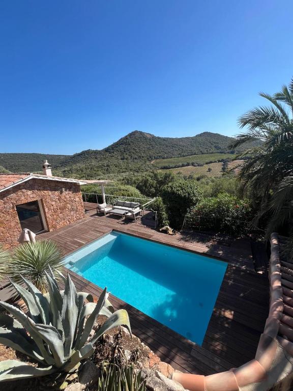 a swimming pool in front of a house at Torraccia in Porto-Vecchio