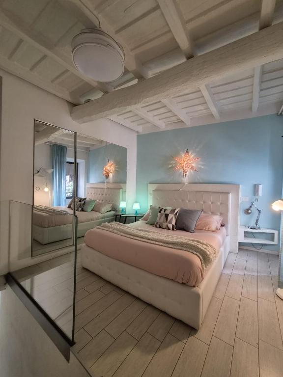 a bedroom with a large bed and a mirror at PapalePapale Home in Viterbo