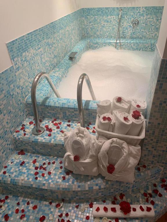 a jacuzzi tub with towels in a bathroom at Eveline Portosole Hotel in Sanremo