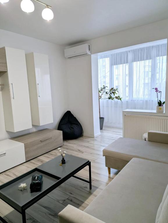 a living room with a couch and a coffee table at Ariana Urban Loft in Târgu-Mureş