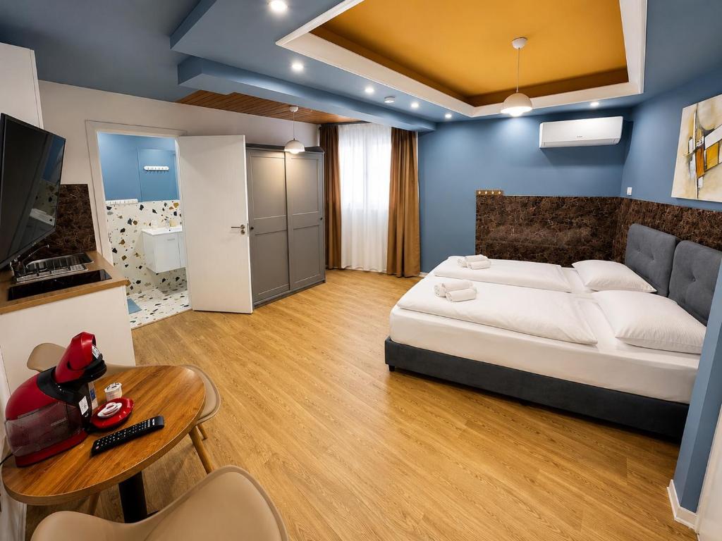a bedroom with a large white bed and a table at Mini Studio N6 private Bathroom and Kitchenette in Limassol