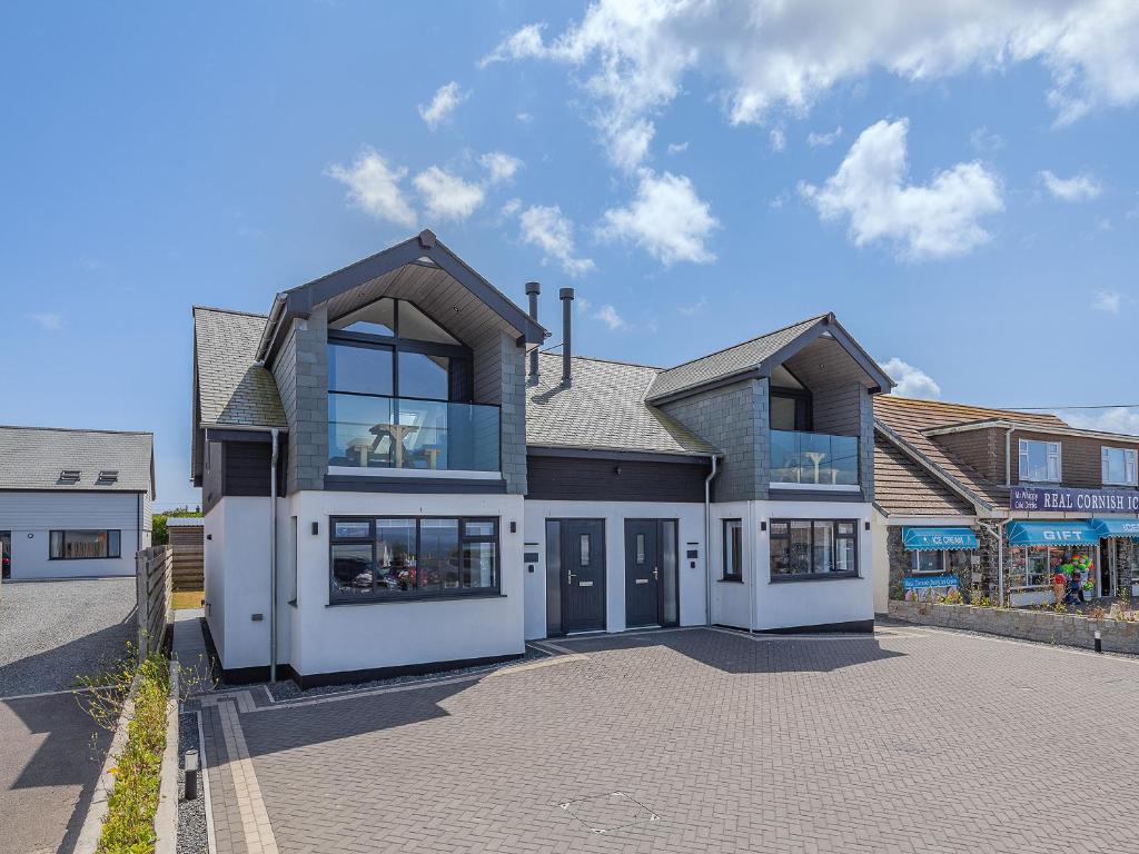 a large house with glass doors on a street at Sea Skapya - Uk50178 in Helston