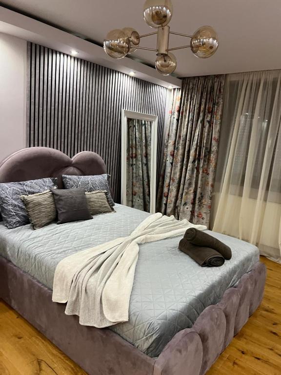 a bedroom with a large bed with a head board at GZP Residence Lugoj 6 in Lugoj