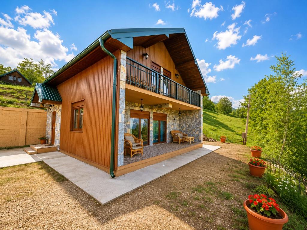 a small house with a balcony and a patio at Gacka Luxury Mountain Villa in Feratovo Polje