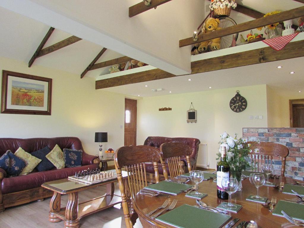 a living room with a table and a couch at Sedge Lodge in Littleport