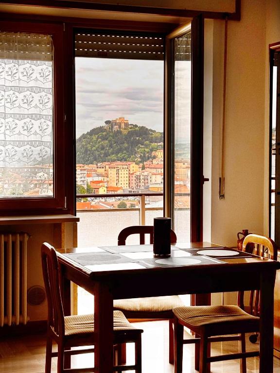 a table and chairs in a room with a large window at La Casa del Benessere in Campobasso