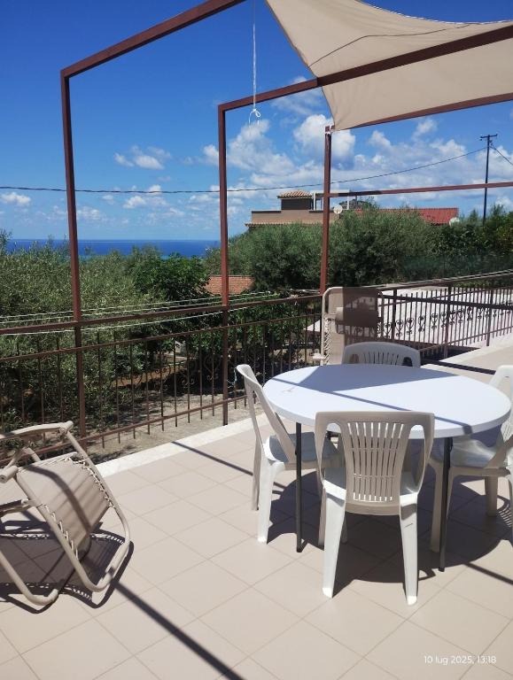 a white table and chairs on a patio with a view at Casa vacanze Torre in Cefalù