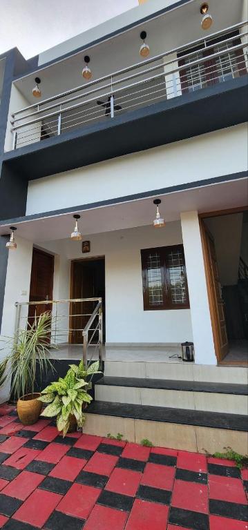a house with a checkered floor in front of it at Pearl's Lake House in Cochin