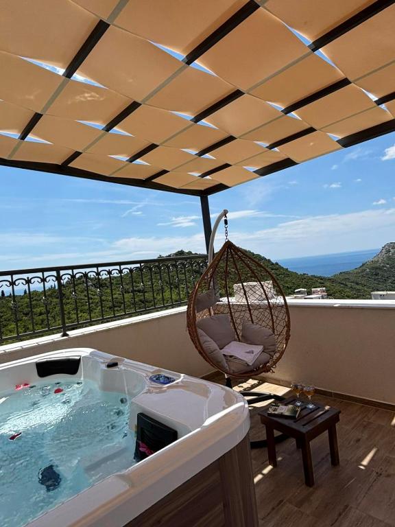 a hot tub on a balcony with a swing at Apartments Nahla in Bar