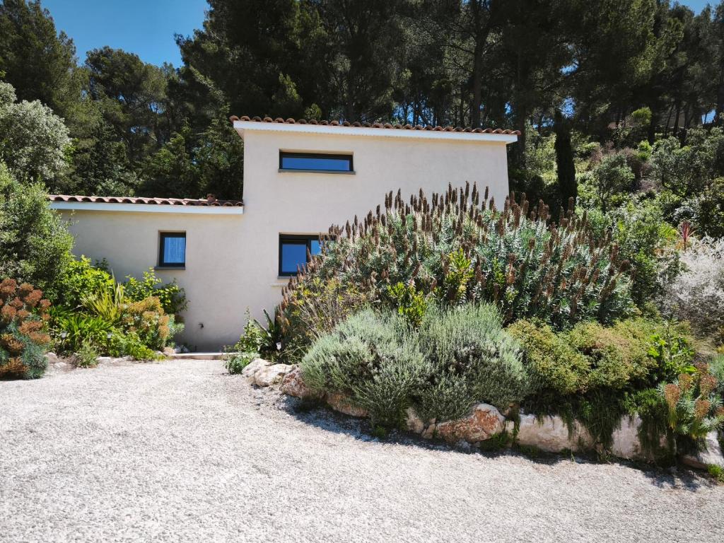 a house with a lot of plants in front of it at La Belle de Cassis in Cassis