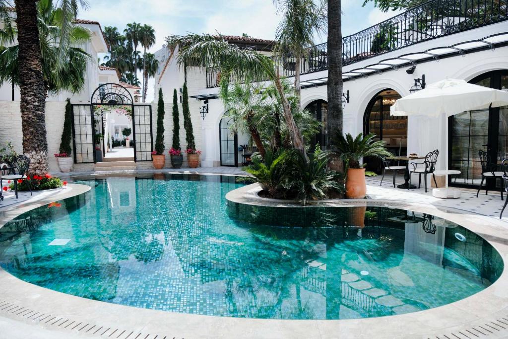a swimming pool in the middle of a building at Elegance East Hotel in Antalya