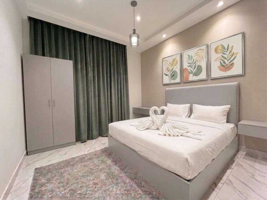 a bedroom with a bed and a green curtain at Aura Downtown Suites in Cairo