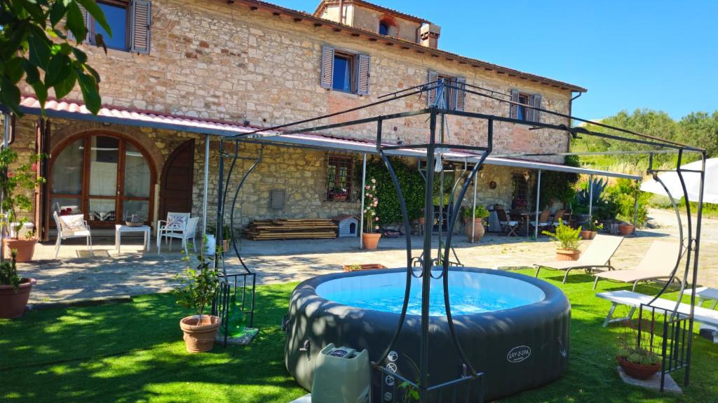 a pool in the yard of a house at Il Peppolo Country House in Pelago