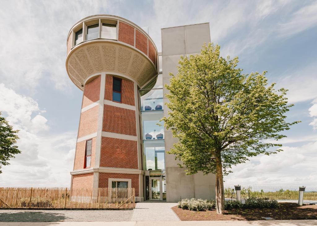 a building with an air traffic control tower at De Droomtoren - uniek overnachten in een watertoren nabij Maastricht in Riemst