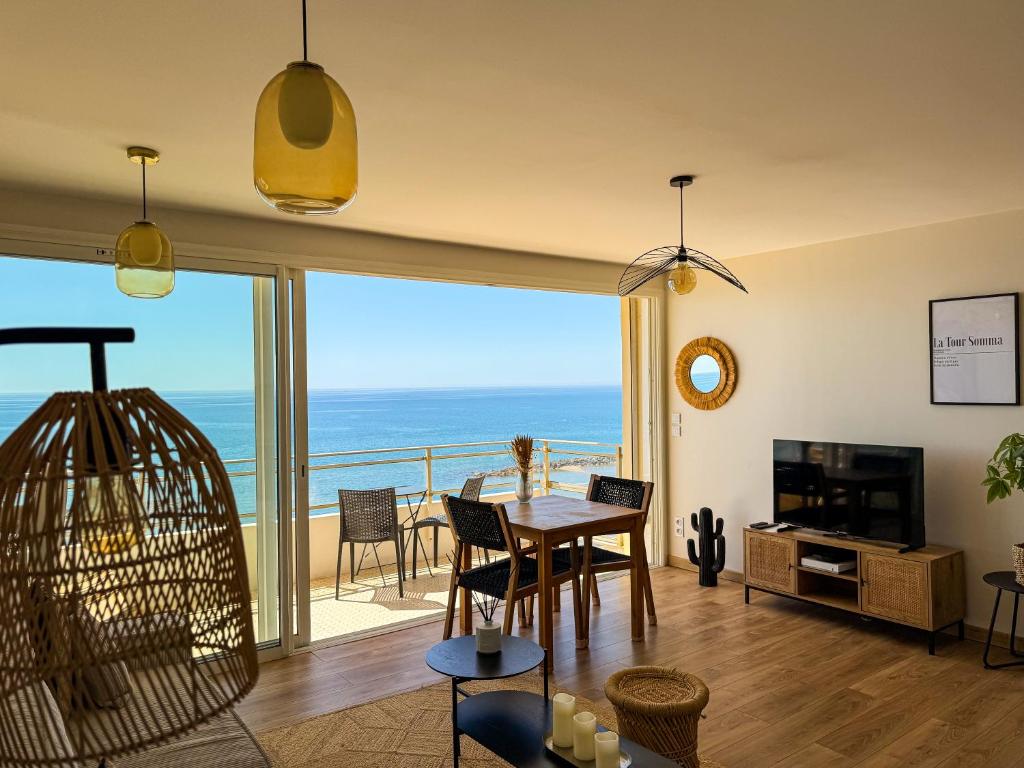 a living room with a view of the ocean at La Tour Somma in Valras-Plage