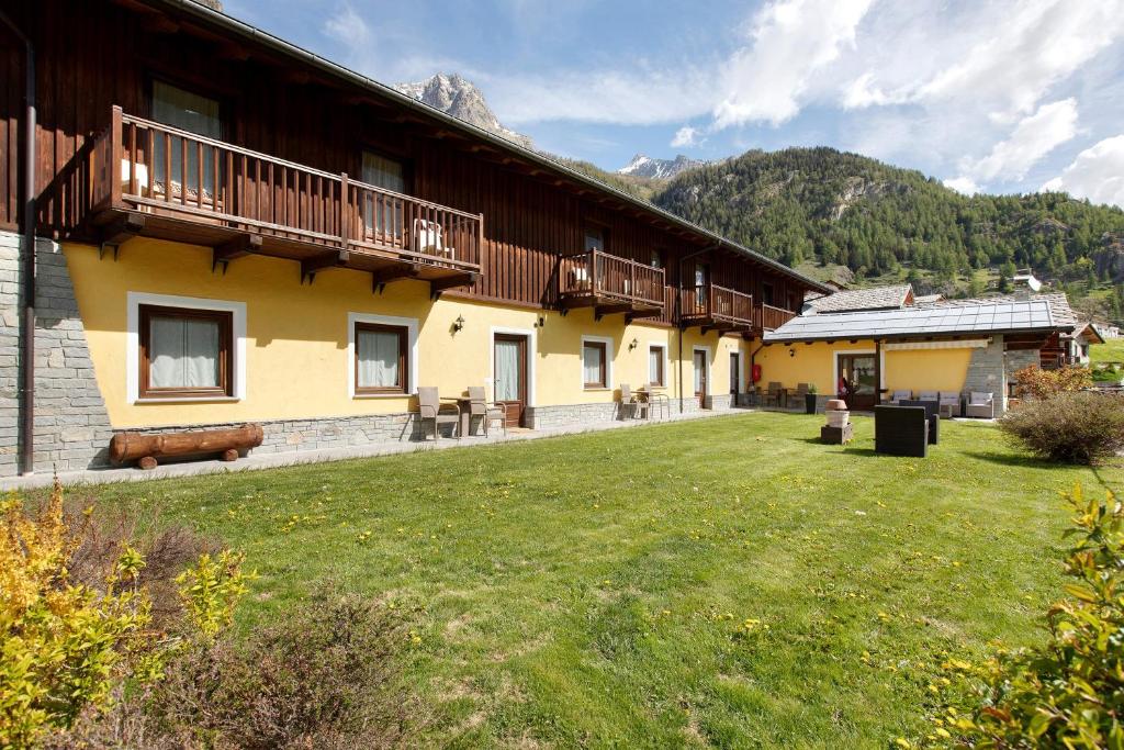 a building with a grass yard in front of it at La Baita - Bionaz in Bionaz