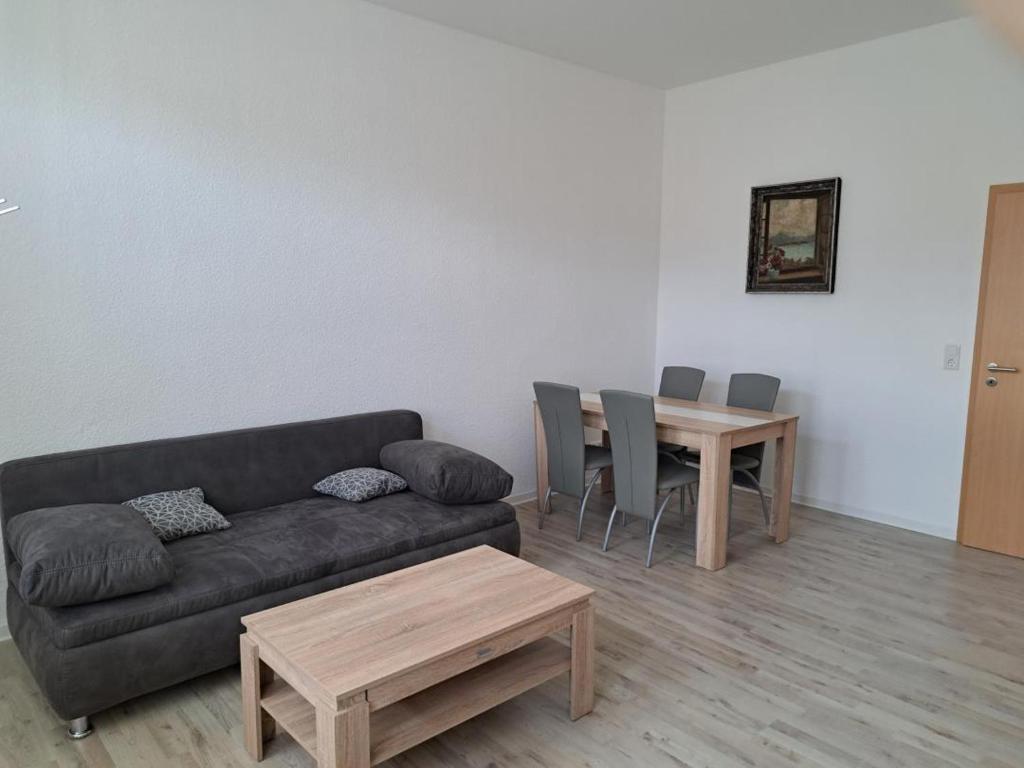 a living room with a couch and a table at NEU! Fewo Calbe an der Saale in Calbe