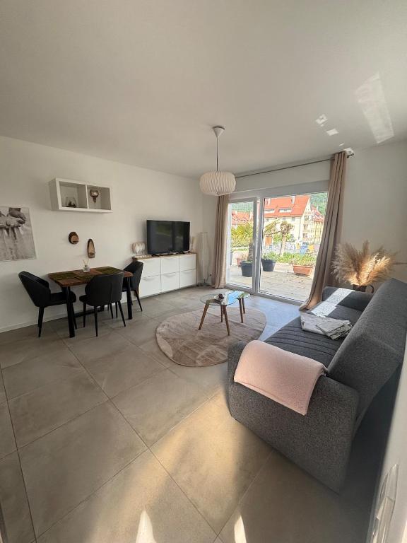 a living room with a couch and a table at Casa Nova Apartment in Geislingen an der Steige