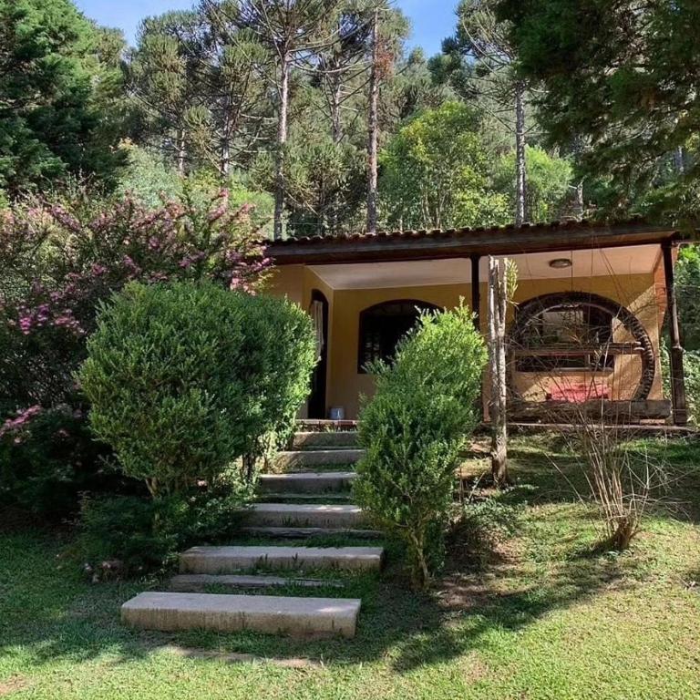 a set of stairs leading up to a house at Chácara Luz do Vale in Votuverava