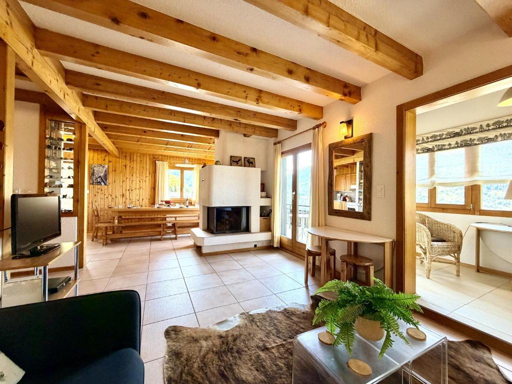 a living room with a couch and a fireplace at Eanta SUNNY & MOUNTAIN chalet 10 pers by Alpvision Résidences in Veysonnaz