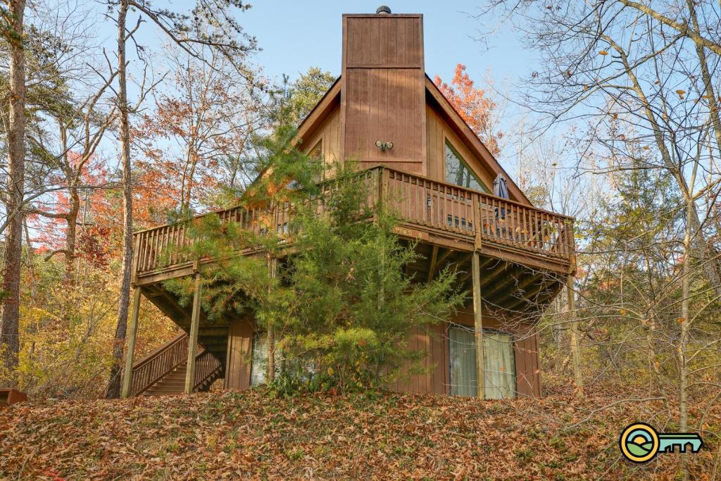 a house with a wrap around deck in the woods at Villa #8 in Basye