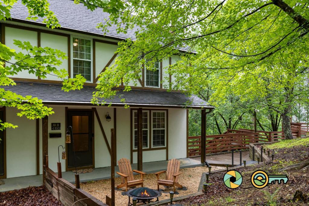 a house with two chairs in front of it at Lakeview 10B: Forest Den in Basye