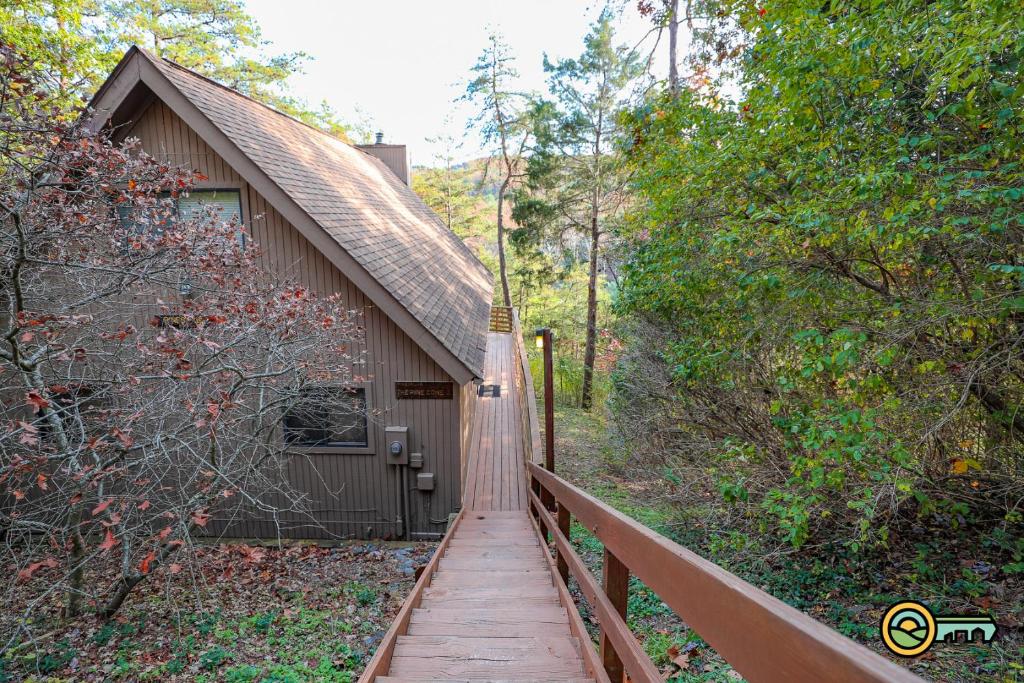 a wooden walkway leading to a building on a bridge at Villa #162 in Basye