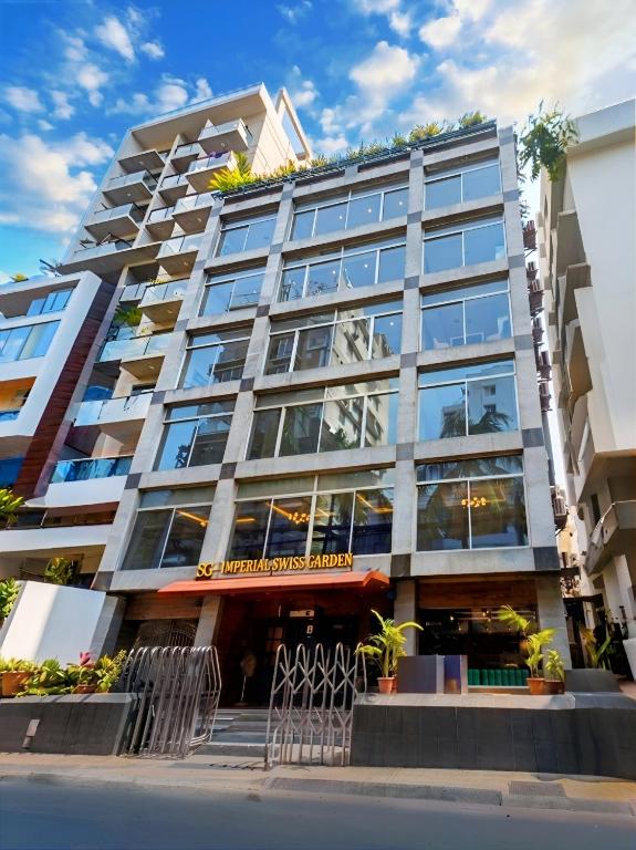 a tall building with windows and plants on it at Imperial Swiss Garden Dhaka in Dhaka