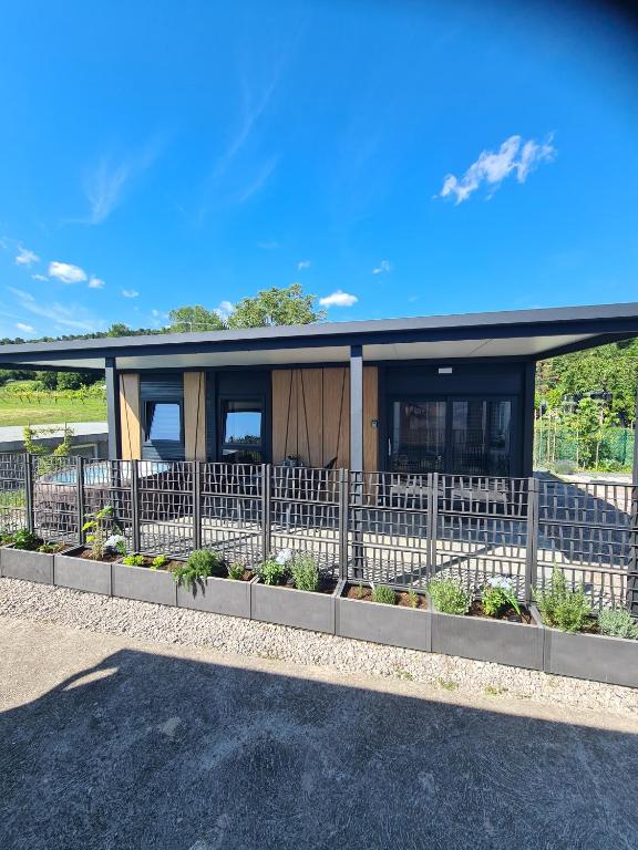 a house with a fence in front of it at Ancarano mobile house & whirlpool in Ankaran