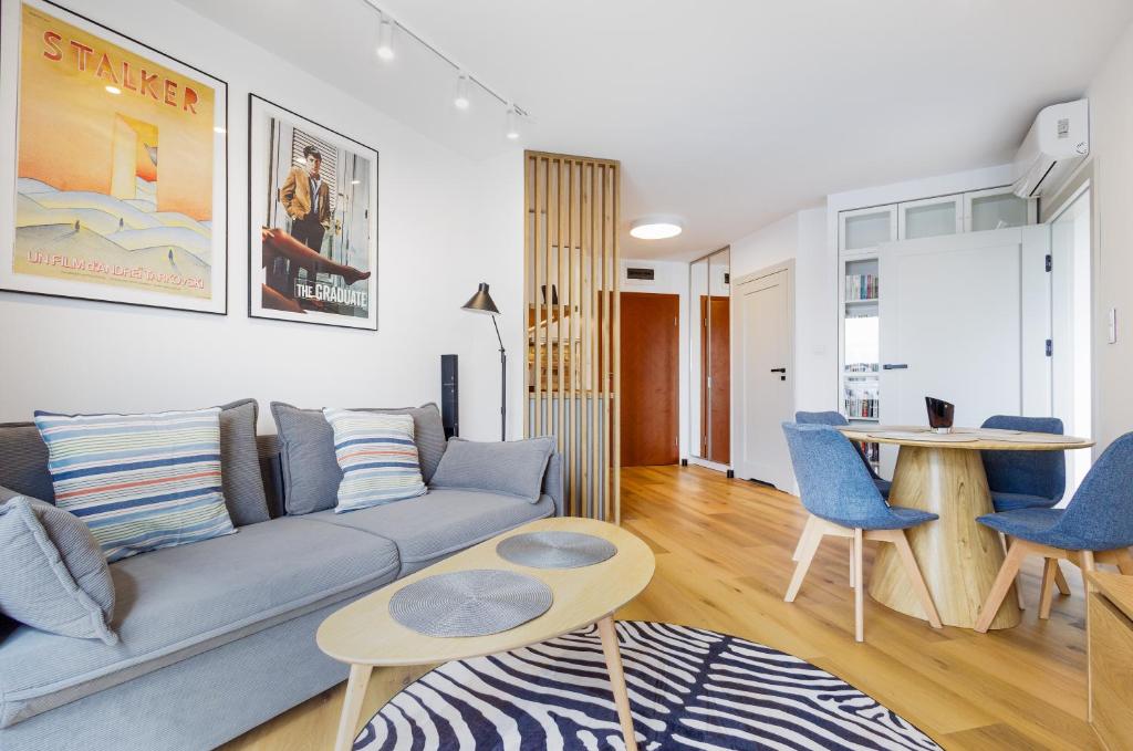 a living room with a couch and a table at BOOKS & SUN by the Sea Air-conditioned Apartment in Władysławowo