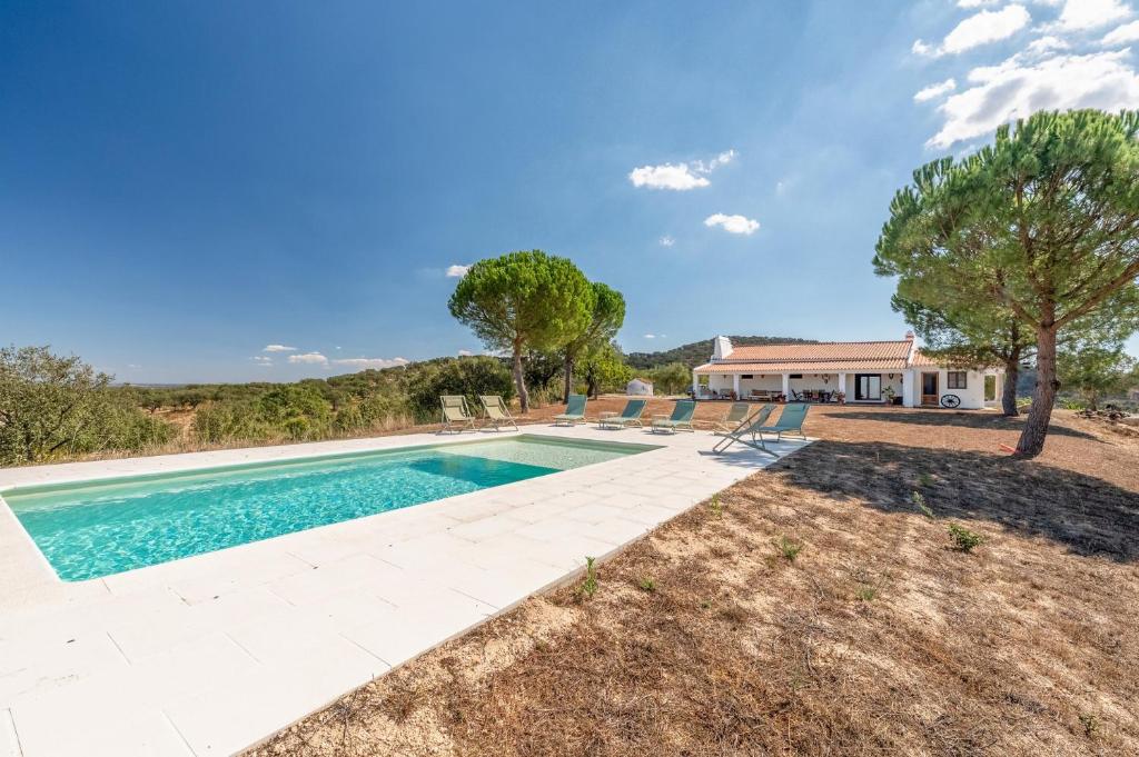 an image of a swimming pool in front of a house at Authentic Alentejo Farmhouse in Arraiolos
