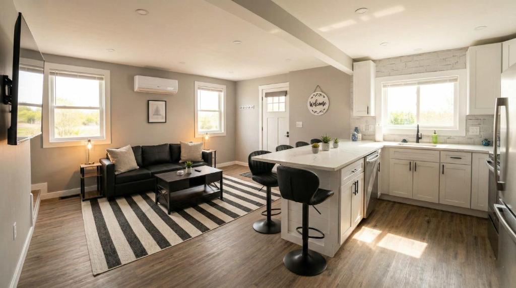 a kitchen and living room with a couch and a table at Sleek Modern Villa - Centrally Located in Wilmington
