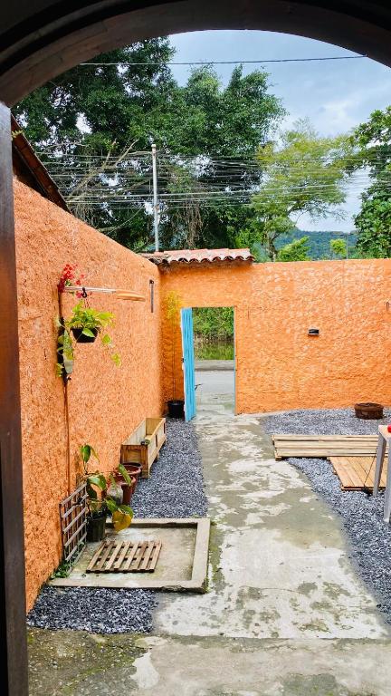 an orange brick building with a courtyard with benches at Hostel Agatha in Paraty