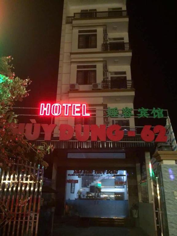 a building with a neon sign in front of it at Thùy Dung 62 in Ha Long