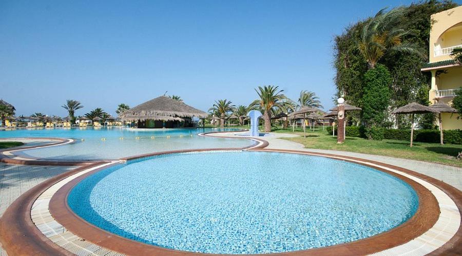 a swimming pool at a resort with a resort at Caribbean World Mahdia in Mahdia
