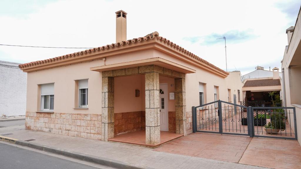 a building with a cross on top of it at Casa Cruces in Sant Jaume d'Enveja