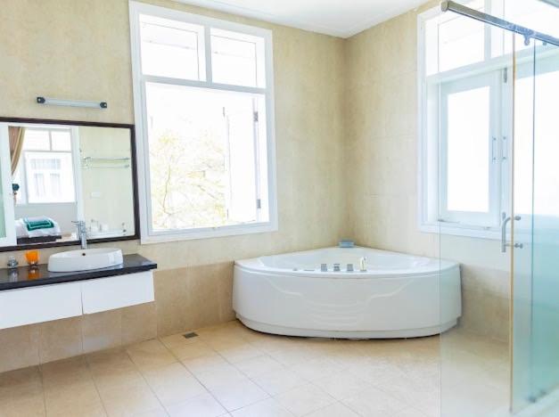 a large bathroom with a tub and a sink at Villa Sealink S15 in Ấp Thiện Phước