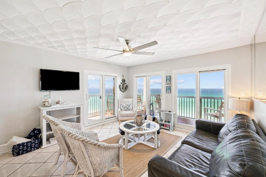 a living room with a couch and a tv at Emerald Hideaway by 30A Escapes in Carillon Beach