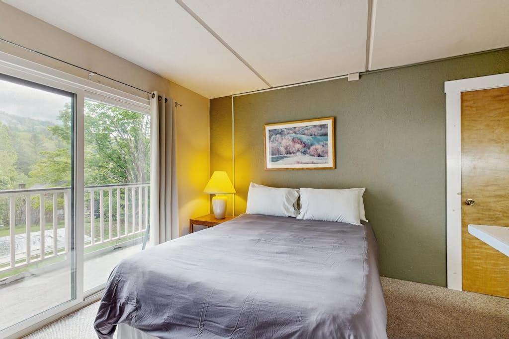 a bedroom with a bed and a large window at Seasons 303 in Warren