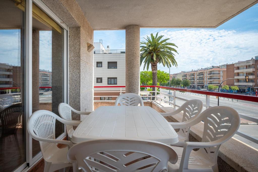 a white table and chairs on a balcony at AT098 Pau Casals in Torredembarra