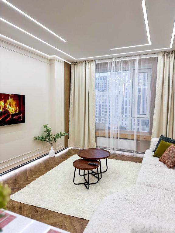 a living room with a couch and a table at DailyRentKZ in Kostanay