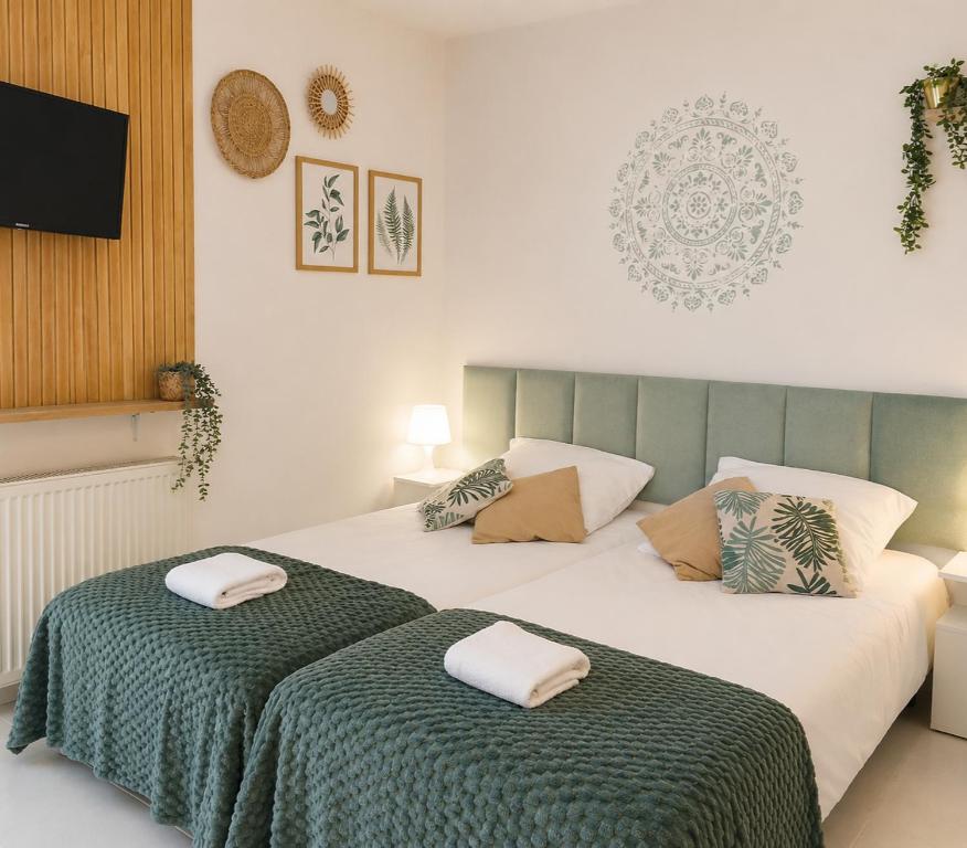 a bedroom with two beds with towels on them at KRK stop near airport in Cholerzyn
