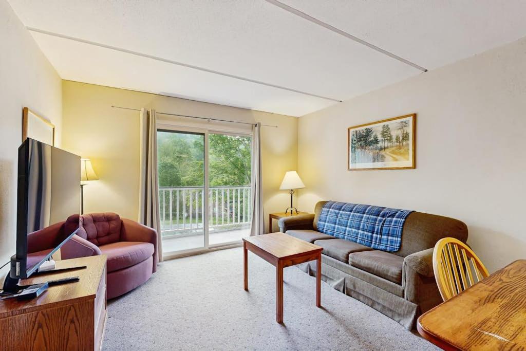 a living room with a couch and a tv at Seasons 304 in Warren