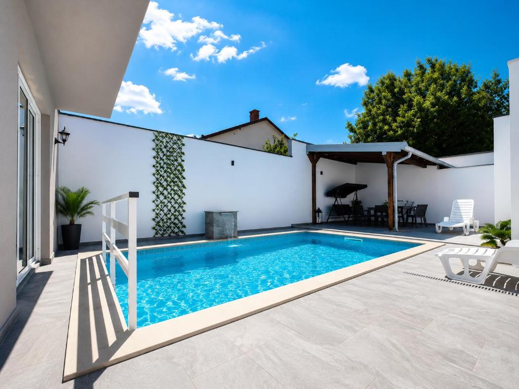 a swimming pool in the backyard of a house at Holiday Home Dalia with Private Pool in Blagaj