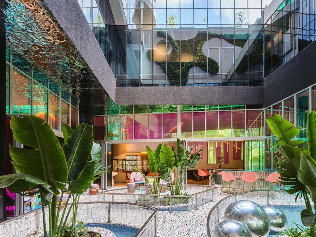 a lobby with plants and a building at Gem Forest Hotel Nairobi - MGallery Collection in Nairobi